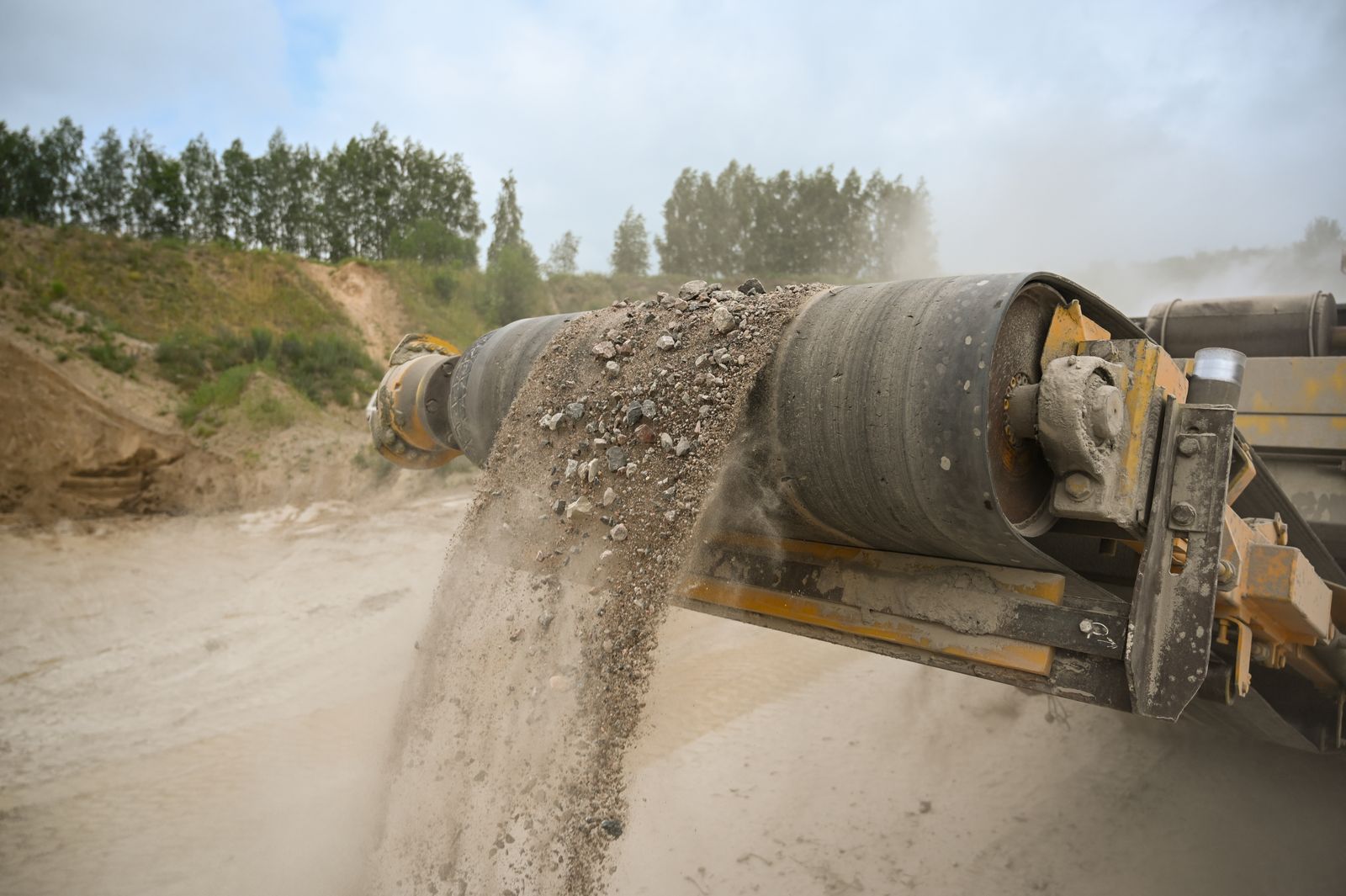 Aggregate moving off a conveyor at a construction materials site