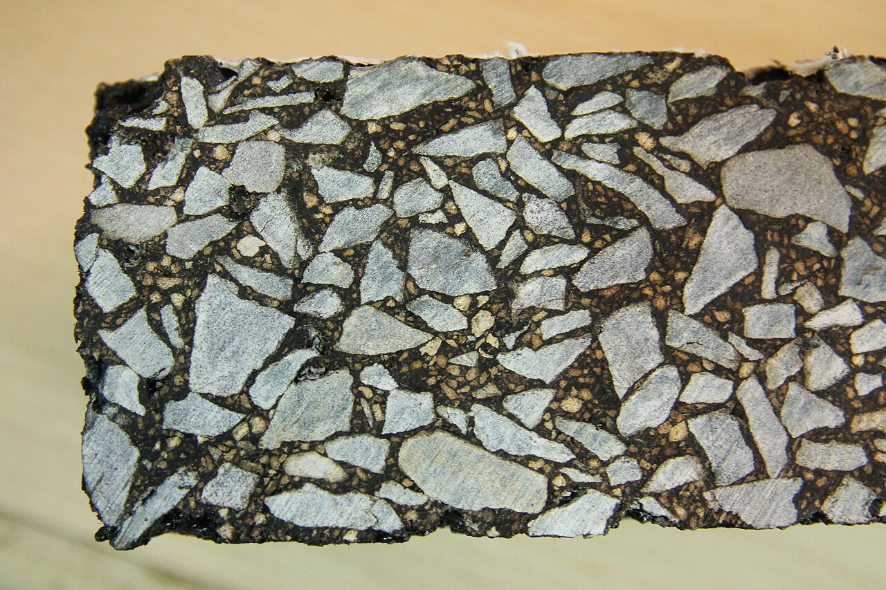 Cut asphalt mixture specimen revealing aggregate and binder structure