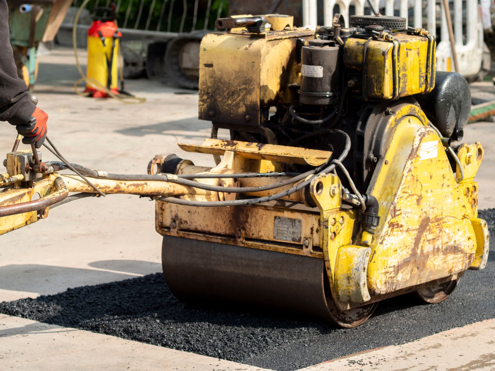 Road roller compacting a fresh asphalt repair